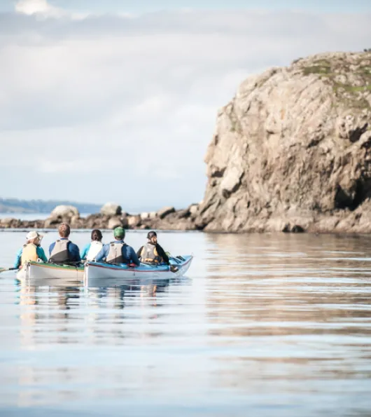 Group boating near rocky outcropping